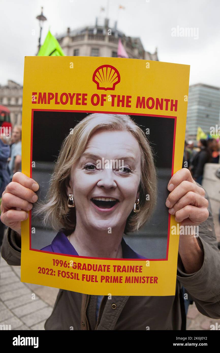 London, UK, 14 October 2022: Extinction Rebellion march down Whitehall to Downing Street, where they symbollically burned energy bills. The slogan of the protest was 'We Can't Afford This', referring both to energy bills in the cost of living crisis and to the climate crisis caused by burning fossil fuels. Posters showed Liz Truss as Employee of the Month, highlighting her connections to the fossil fuel industry. Anna Watson/Alamy Live News Stock Photo