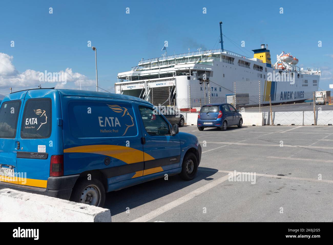 Heraklion, Crete, Greece.2022. Greek postal service vans at the ferry port in the port of Heraklion and a inter island ferry in the background Stock Photo