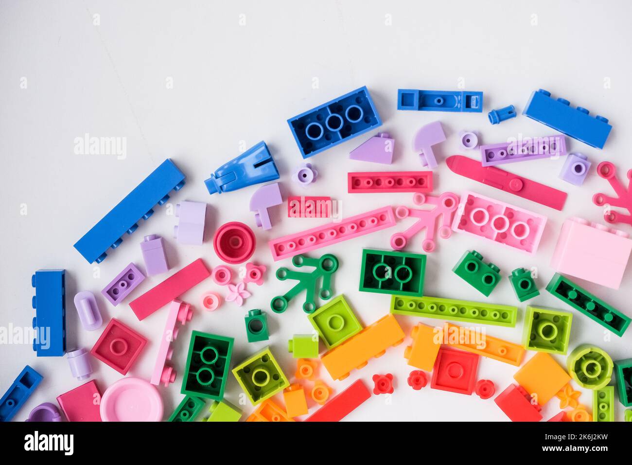 Flat lay colorful plastic building blocks on white background. Baby ...
