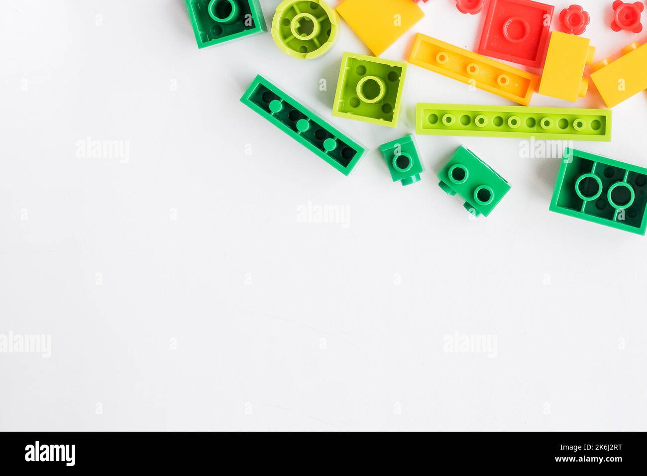 Flat lay colorful plastic building blocks on white background. Baby ...
