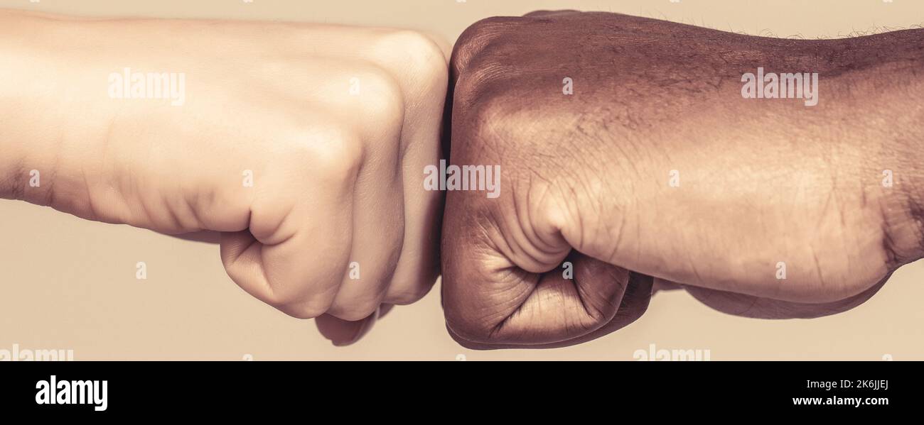 Stop racism campaign. Closeup of multicultural friends giving fist bump ...