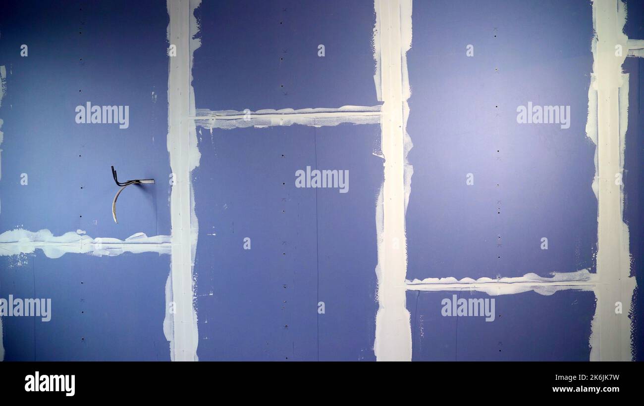 Blue drywall on the wall in a new apartment. Installation or renovation