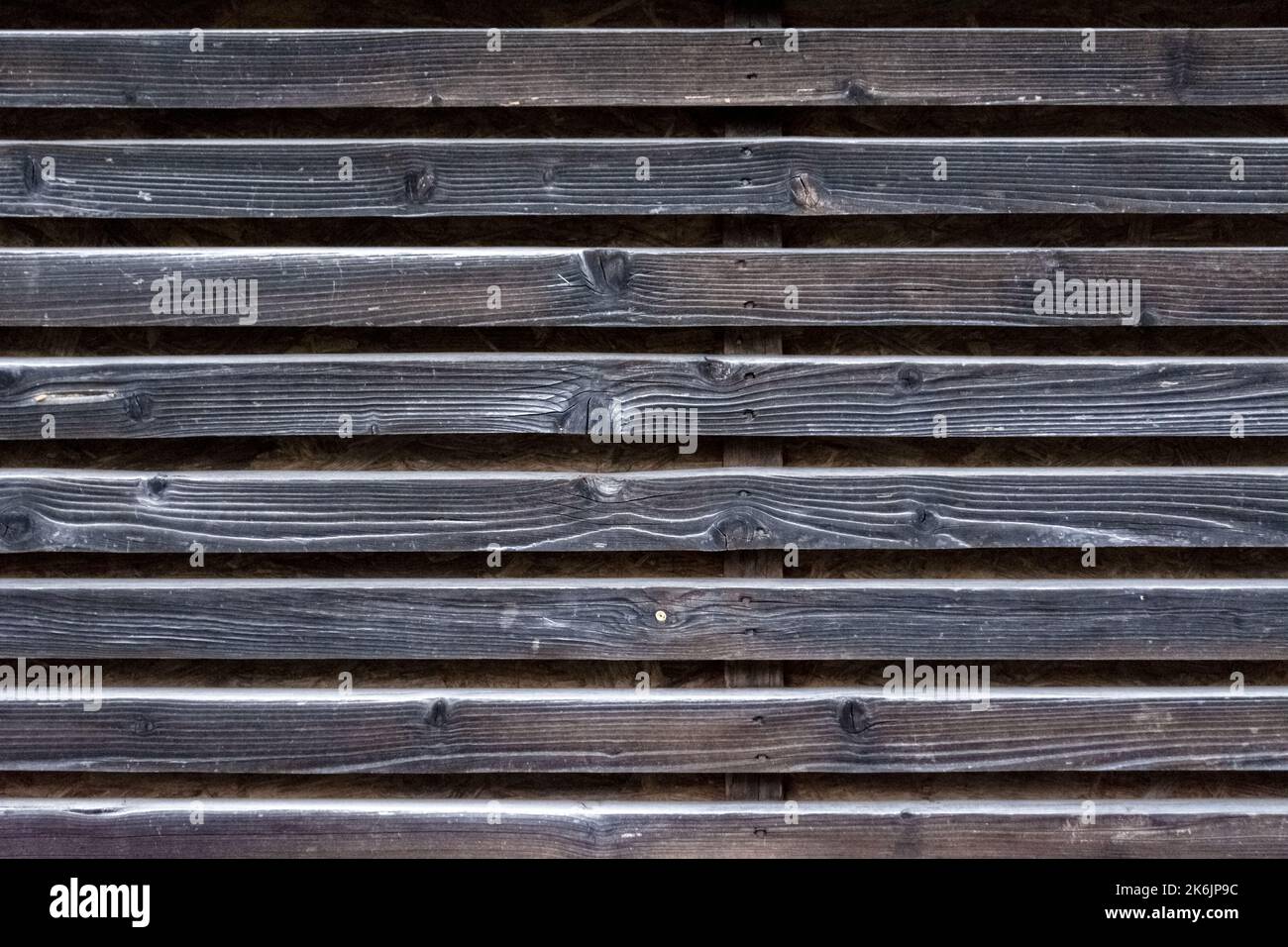 Fragment of a wall made of old wooden weathered slats. For use as an abstract background. Stock Photo