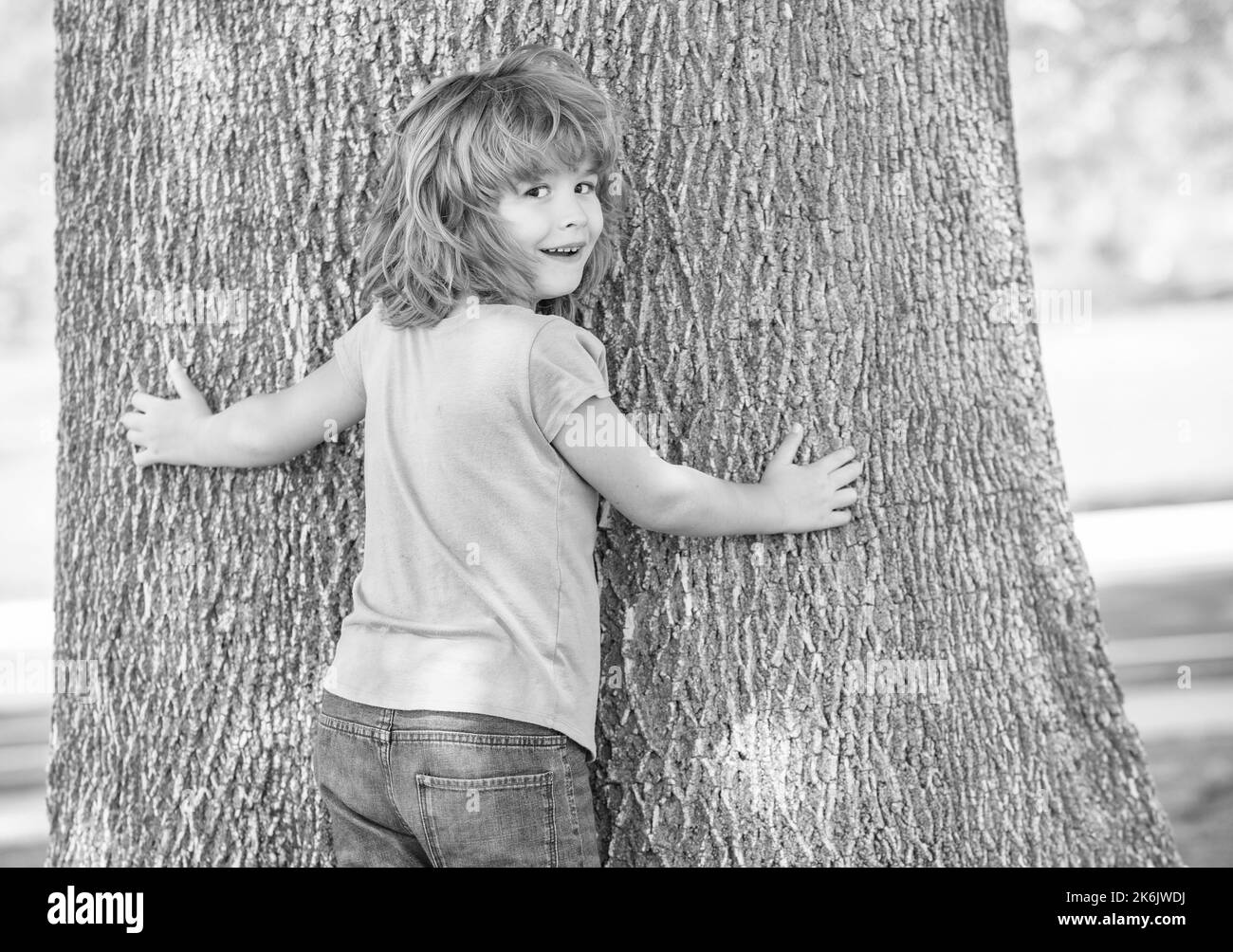 Its so wide. Boy child try to climb tree. Childhood and boyhood. Boyhood days. Tree climbing Stock Photo