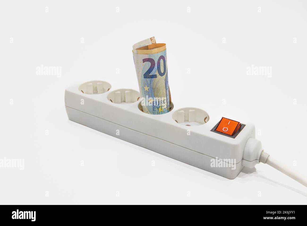 Euro banknotes plugged into the power strip. Concept of expensive electricity prices Stock Photo