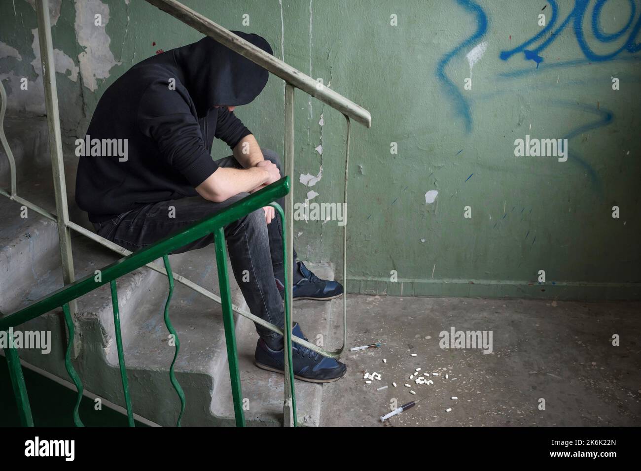 Addict in an abandoned house, experiencing a drug addiction crisis