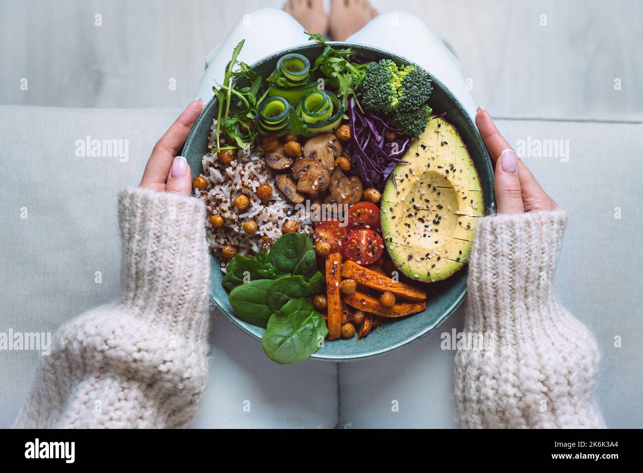 Healthy eating. Plate with vegan or vegetarian food in woman hands. Healthy plant based diet. Healthy dinner. Buddha bowl with fresh vegetables Stock Photo