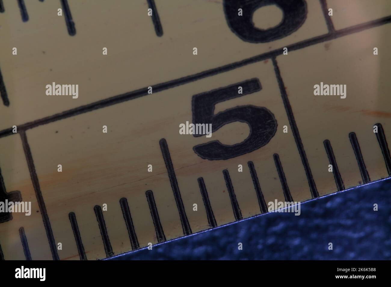 Close-up of the yellow measuring tape indicating the measure 5. Number five Stock Photo