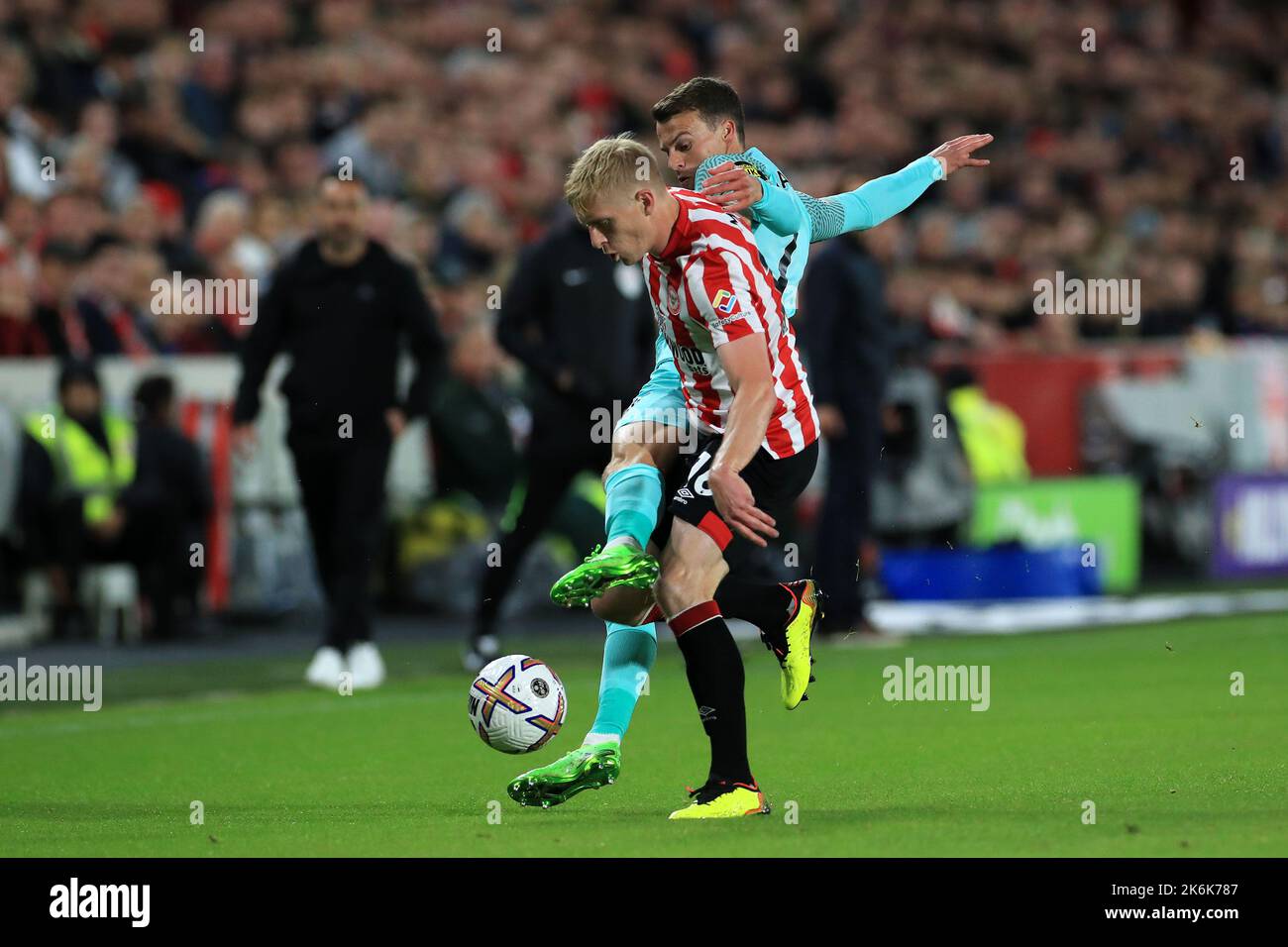 London, UK. 14th Oct, 2022. Solly March #7 of Brighton & Hove Albion challenges Ben Mee #16 of Brentford during the Premier League match Brentford vs Brighton and Hove Albion at Brentford Community Stadium, London, United Kingdom, 14th October 2022 (Photo by Carlton Myrie/News Images) in London, United Kingdom on 10/14/2022. (Photo by Carlton Myrie/News Images/Sipa USA) Credit: Sipa USA/Alamy Live News Stock Photo