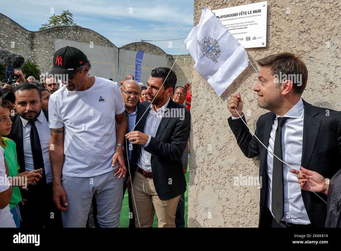 Marseille, France. 12th Oct, 2022. Yannick Noah, accompanied by the mayor of Marseille Benoit Payan, inaugurates his first Playground. The inauguration of the first playground of the ''FÃªte le Mur'' association, an association that Yannick Noah, tennis champion and President of the association created in 1996 for education and integration of young people from disadvantaged neighbourhoods. The association wants to offer young Marseilles from underprivileged neighbourhoods a sport other than football. The terrain includes directly integrated educational elements allowing a reduction in equipm Stock Photo