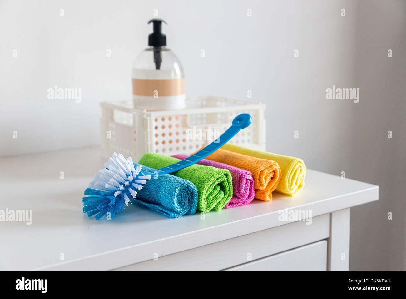Multi-colored fiber cloths for dusting and a plastic brush Stock Photo
