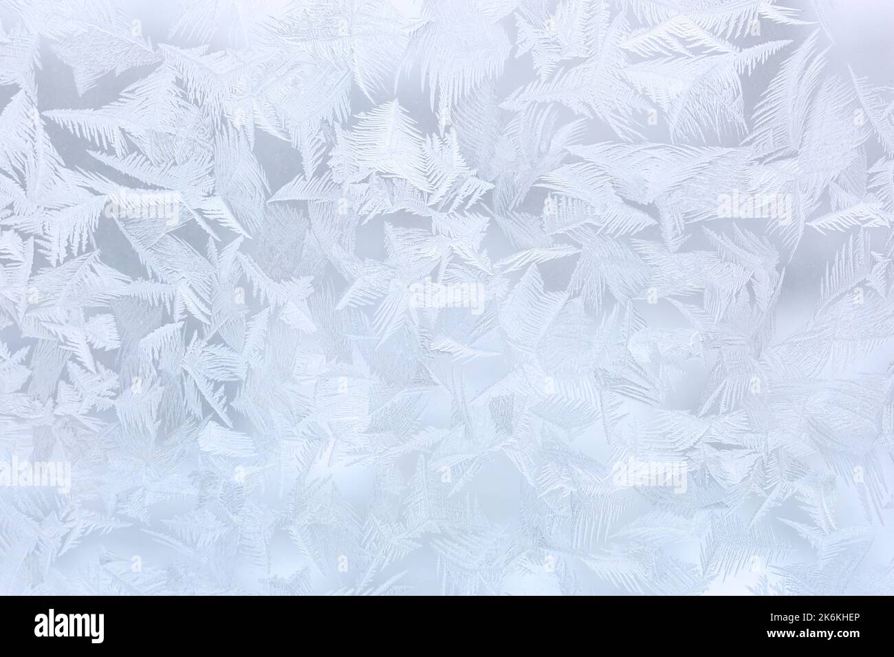 frosty patterns on glass, silver Christmas background Stock Photo