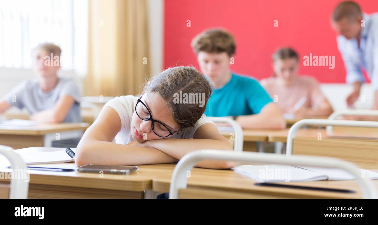 Girl sleeping on desk Stock Photo