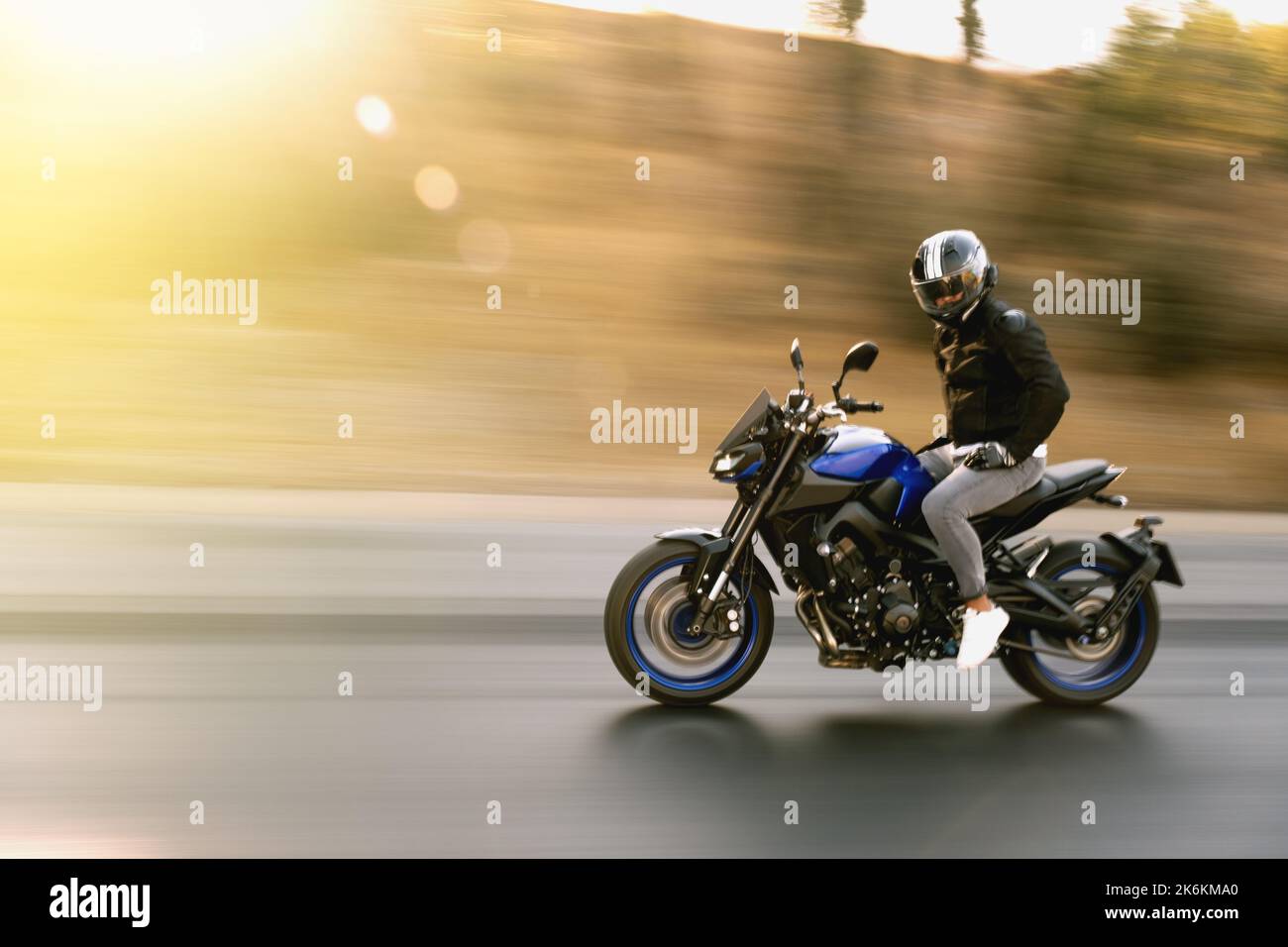 Man riding a supersport motorcycle with no hands on highway Stock Photo Alamy