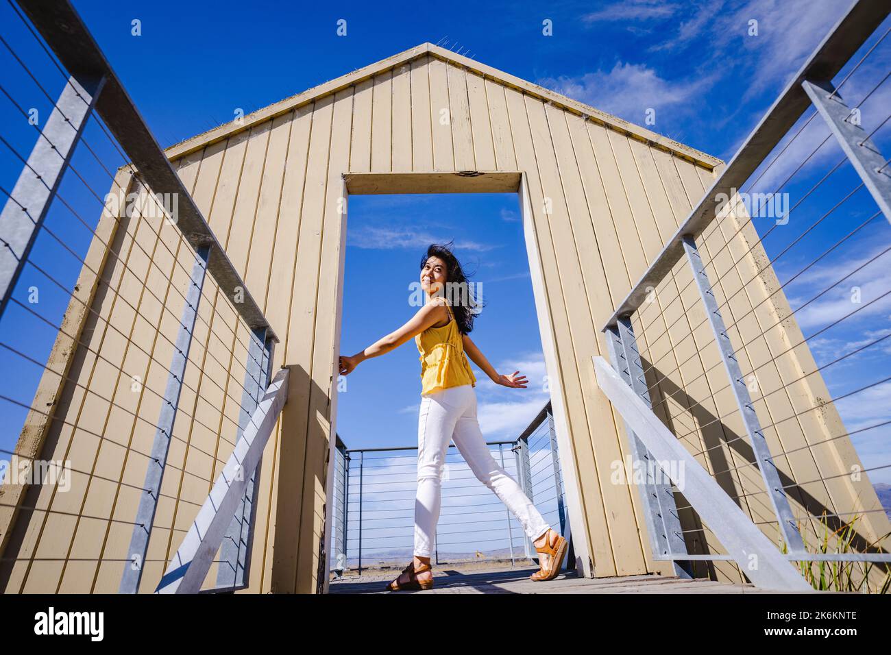 Young Woman Standing in a Doorway to Nature Stock Photo