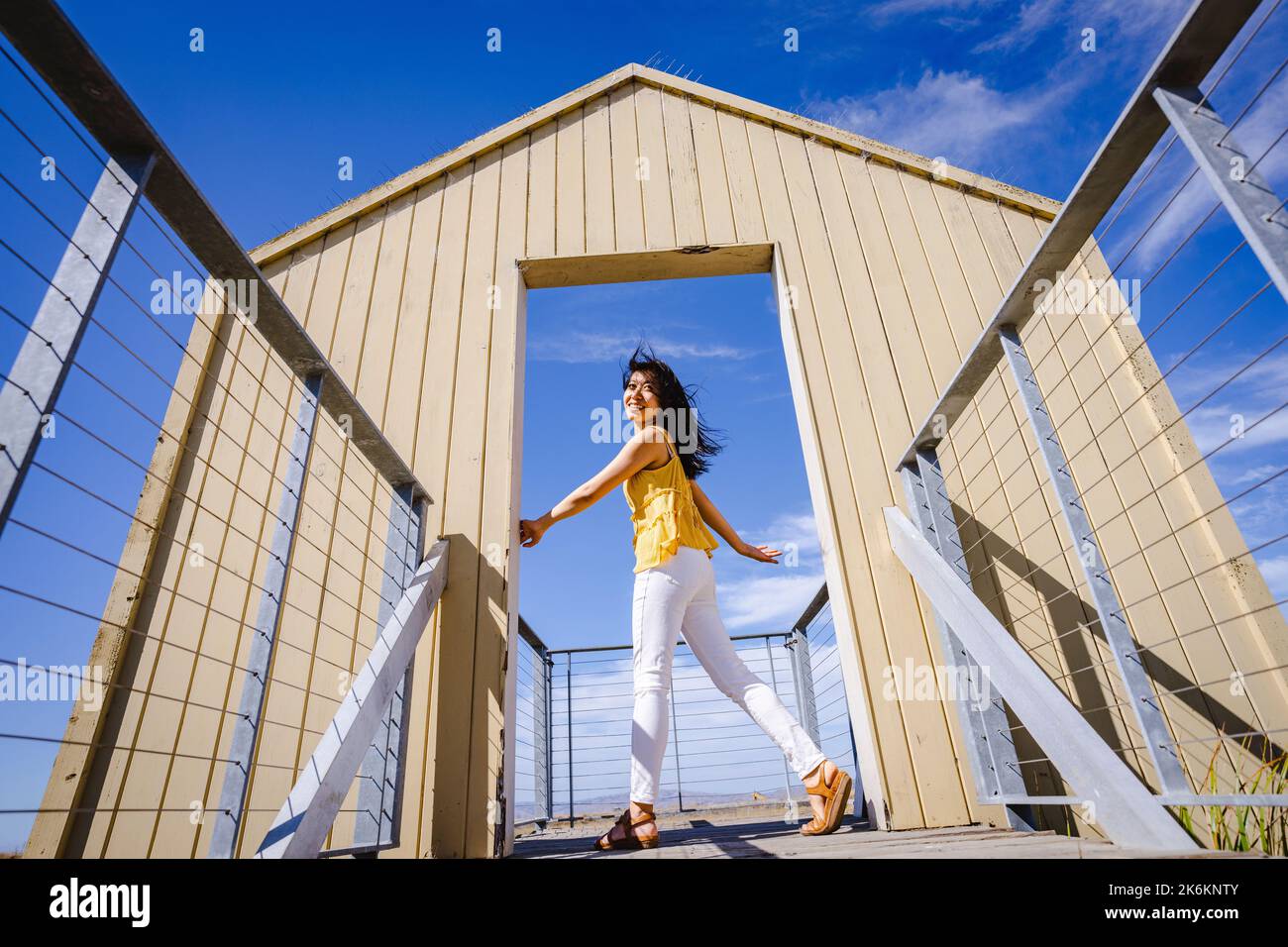 Young Woman Standing in a Doorway to Nature Stock Photo