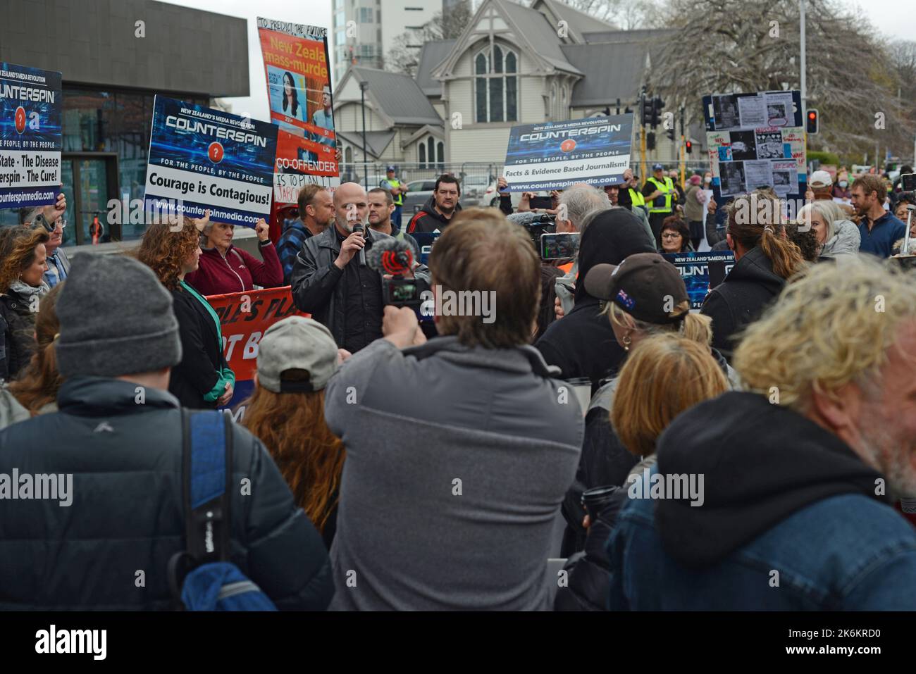 CHRISTCHURCH, NEW ZEALAND, SEPTEMBER 21, 2022: Counterspin Media Director Kelvyn Alp  addresses supporters outside the Christchurch Court House, New Zealand. Alp and fellow director Hannah Spierer (in green, at left) have elected a trial by jury over allegations of publishing objectionable material about the Christchurch Mosque Shooting. Stock Photo