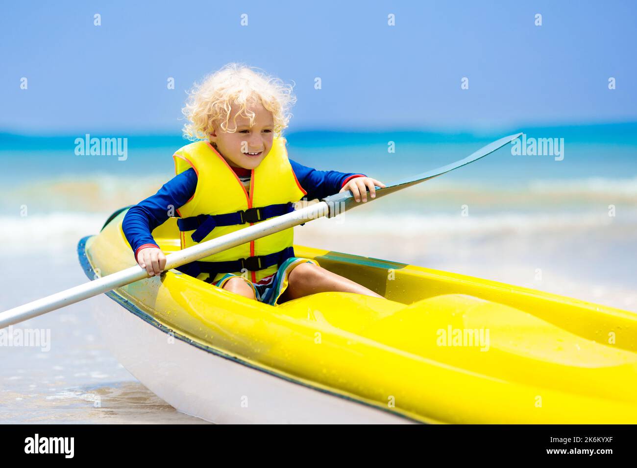 Kids kayaking in ocean. Children in kayak in tropical sea. Active