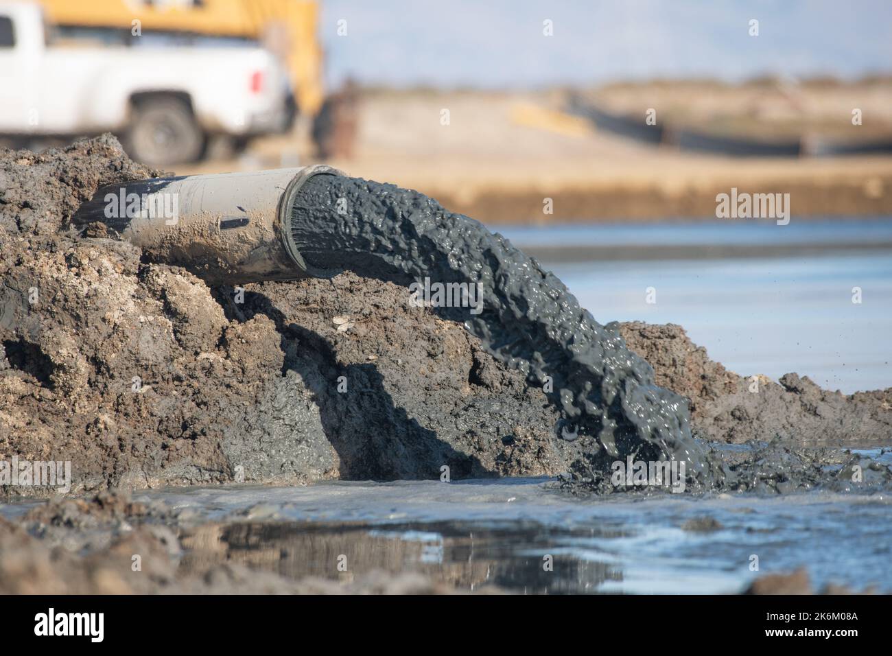 A pipe discharging sludge in the San Francisco Bay area of California