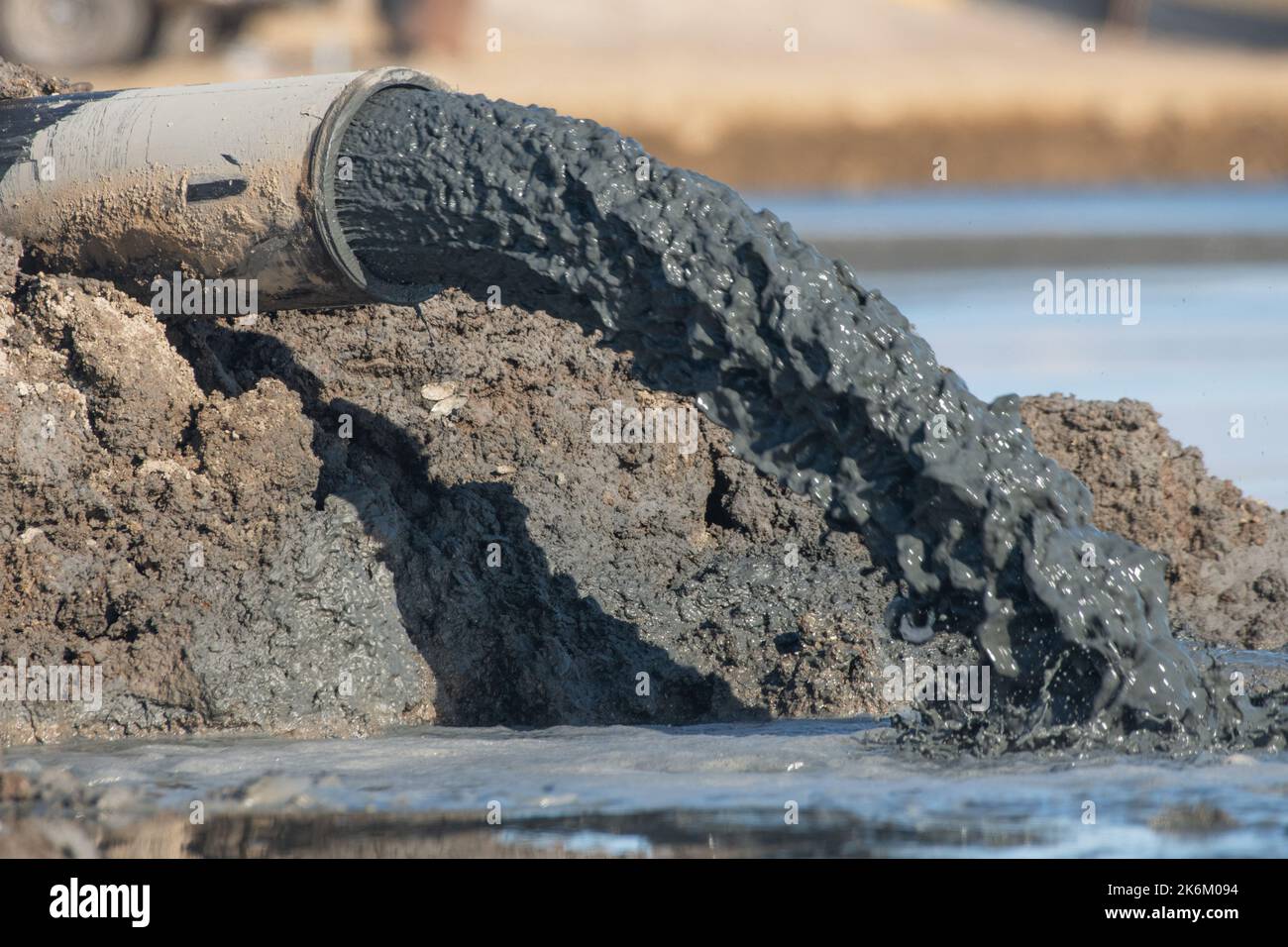 A pipe discharging sludge in the San Francisco Bay area of California. Stock Photo
