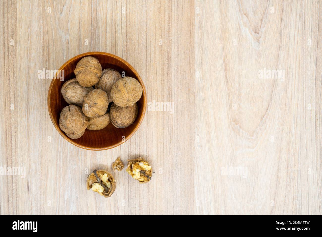 Hazelnuts in a bowl on the table. Flat lay. Stock Photo
