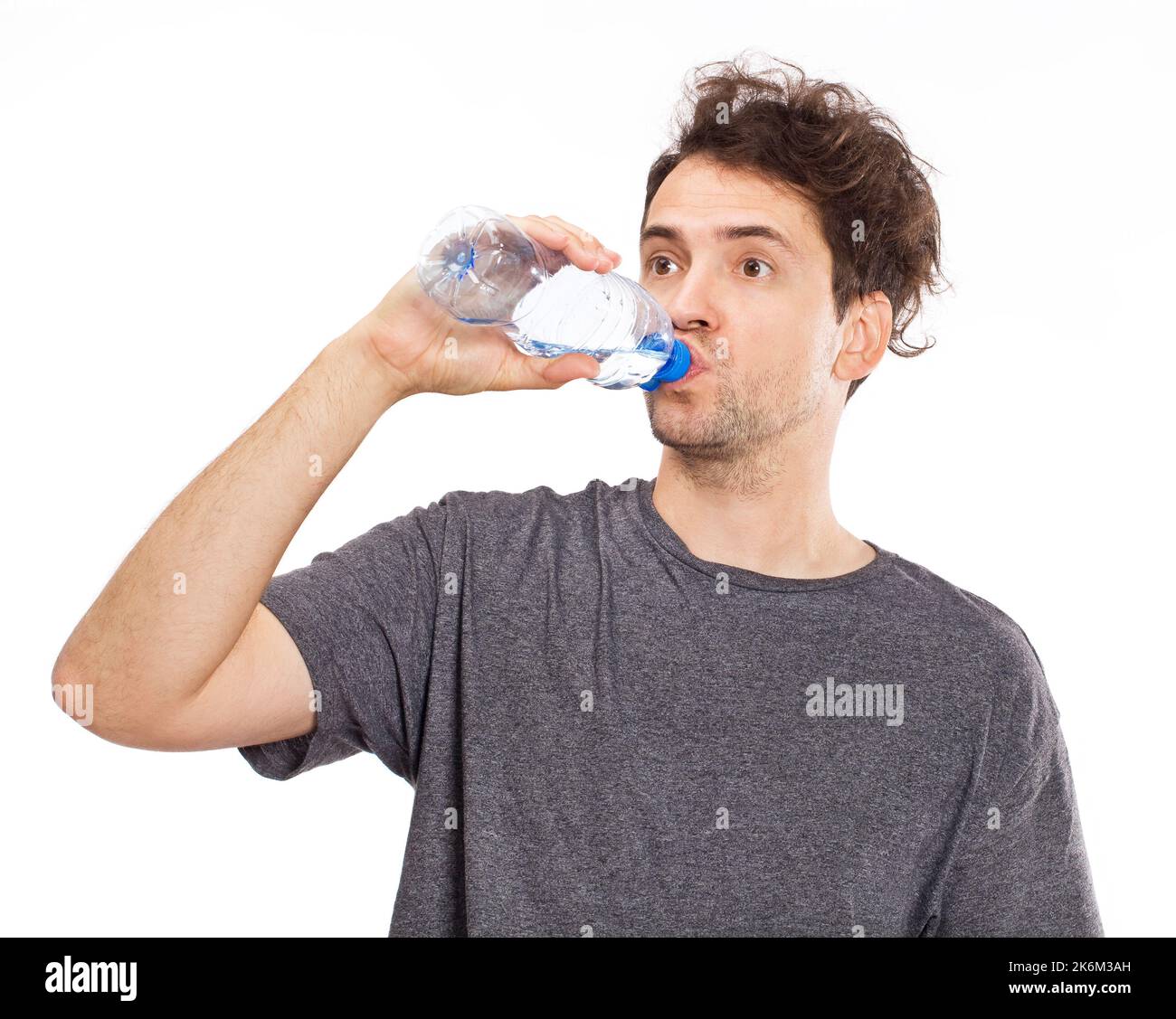 Portrait of a handsome man drinking water. Isolated on white Stock Photo