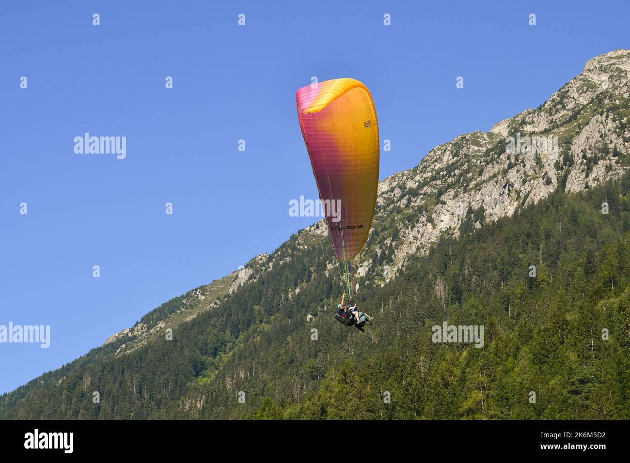 Tandem paragliding in front of the Brevent mountain of the French Alps in summer, Chamonix, Haute-Savoie, France Stock Photo