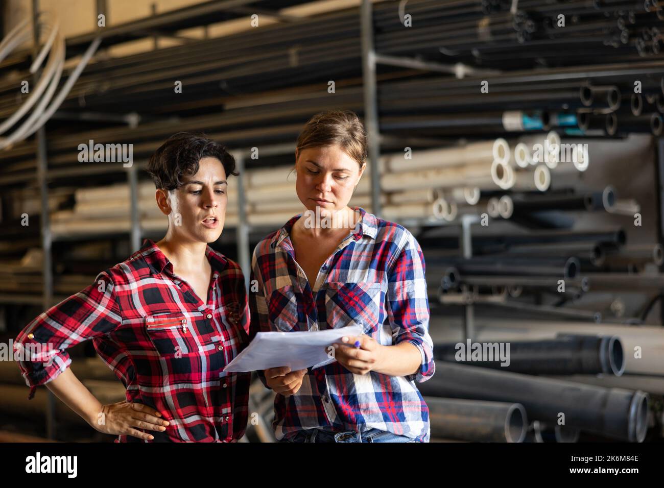 Women working in warehouse, checking documents Stock Photo