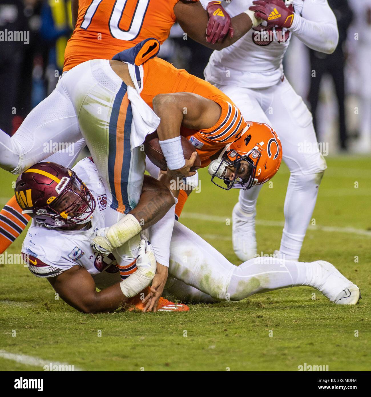 Chicago, Illinois, USA. 13th Oct, 2022. - Chicago Bears Quarterback #1  Justin Fields is sacked by Washington Commanders #93 Jonathan Allen during  the game between the Washington Commanders and the Chicago Bears