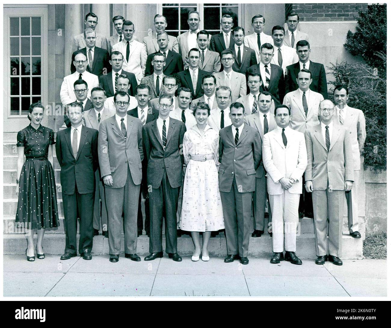 Junior FSO-6 Graduation Class in Front of the Foreign Service Institute. Front row (left to right): Ruth Moore; Robert P. Smith; George B. High; John C. Dorrance; Sharon Erdkamp; Edward J. Streator; Herbert Levin; and Richard G. Long. Second Row: Edwin G. Croswell; Robert K. Olson; Maynard W. Glitman; Charlie L. Young; Frank C. Carlucci; and Joseph J. Montllor. Third Row: Stanley P. Harris; Edward T. Walters; Franklyn E. Stevens; Thomas T. Killoran; Richard D. Chapman; and Walter V. Hall. Fourth Row: Charles R. Stout; Richard H. Morefield; Bernard J. Rotklein; Roderick Grant; Stuart H. McIntyr Stock Photo