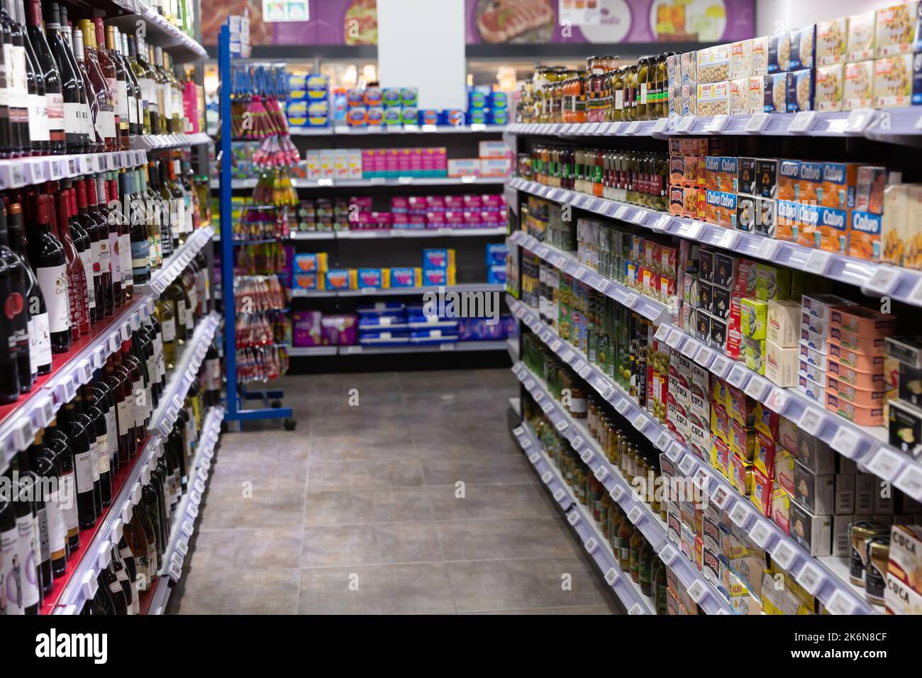 Variety of bottles and cans with soft drinks and alcoholic beverages on