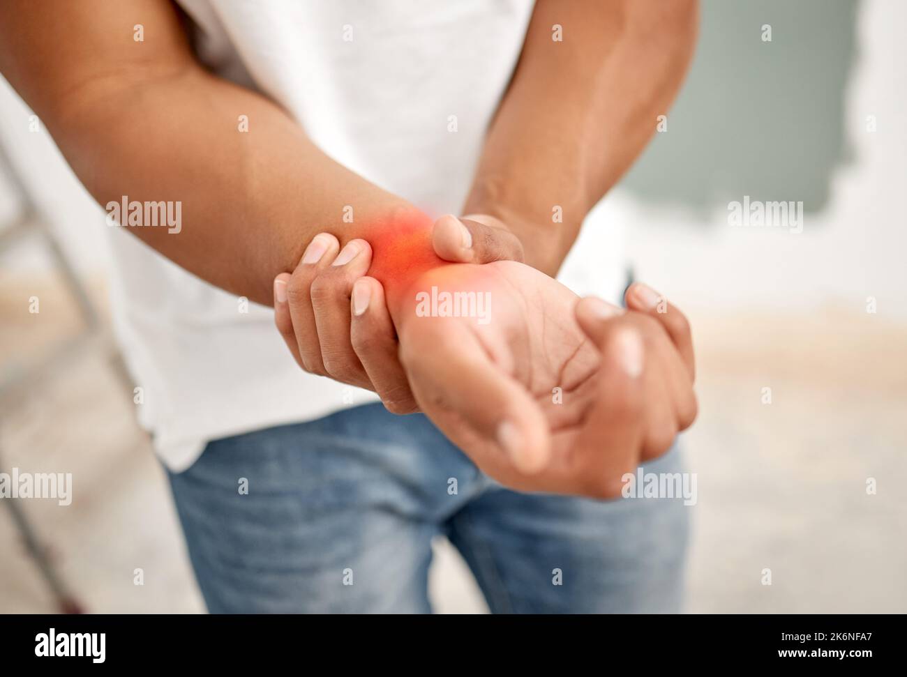 This where I feel the pain. an unrecognizable man experiencing discomfort in his wrist. Stock Photo