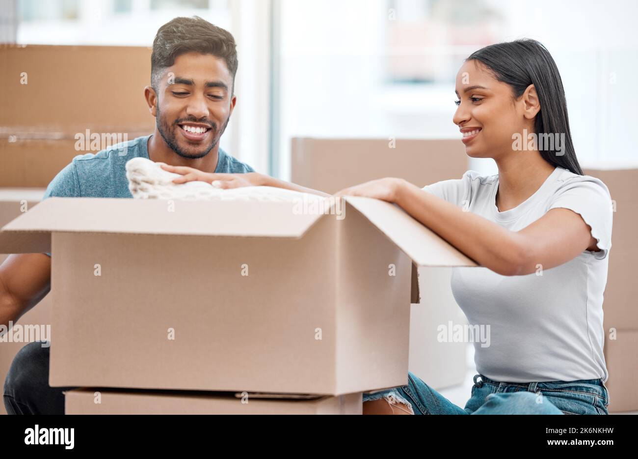 I was wondering where this was. a young couple unpacking boxes together ...