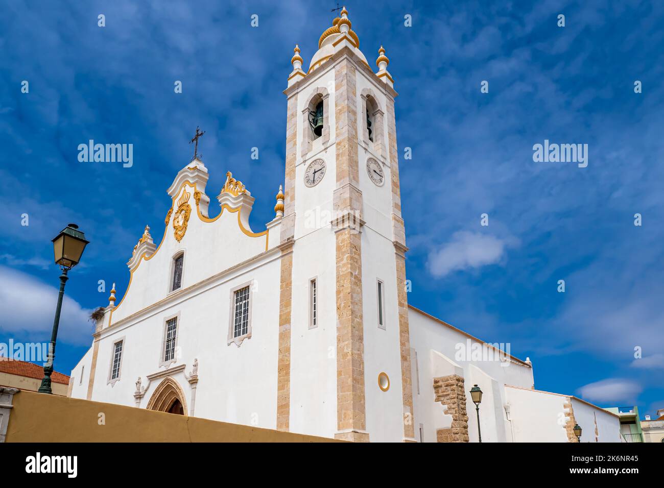 Low angle view of Baroque style white main church of the city Portimao in the Algarve area in Portugal called Igreja de nossa Senhora da Conceição . Stock Photo
