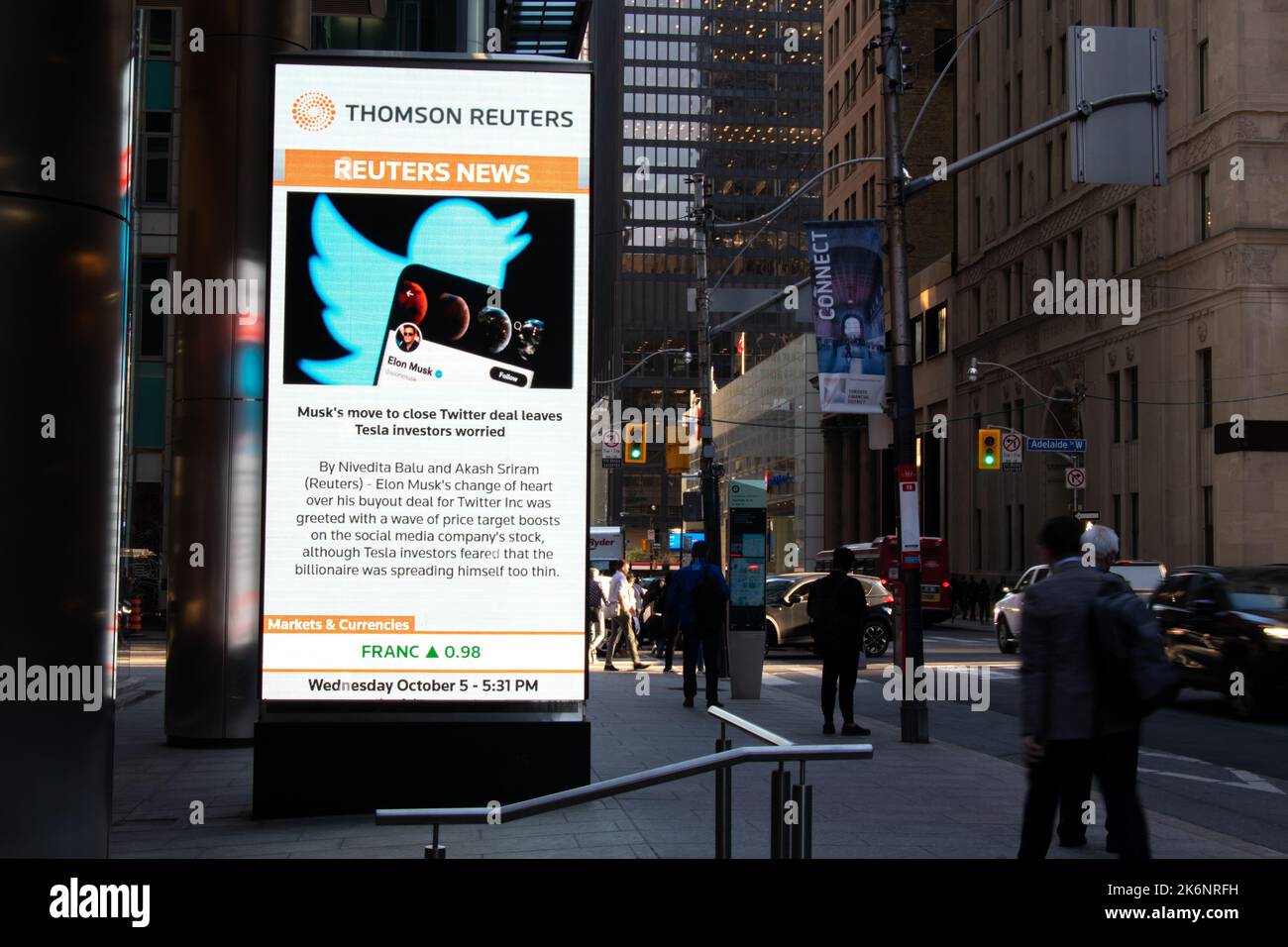 A Thomas Reuters news headline is seen in Toronto's Financial District; about Elon Musk's plans to proceed with the purchase of Twitter, Inc. (TWTR). Stock Photo