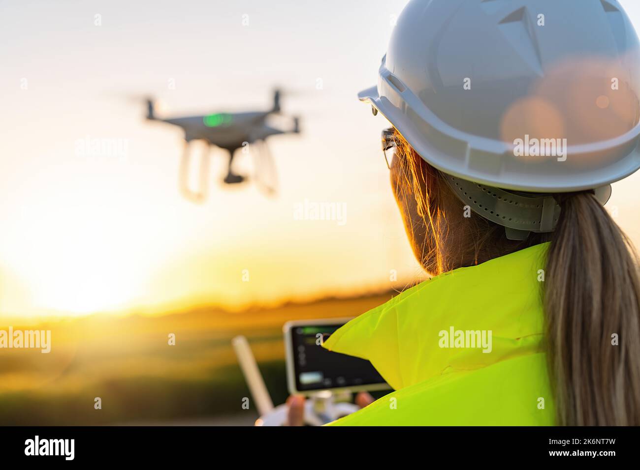 Drone inspection. Female Operator inspecting Wind turbine with drone