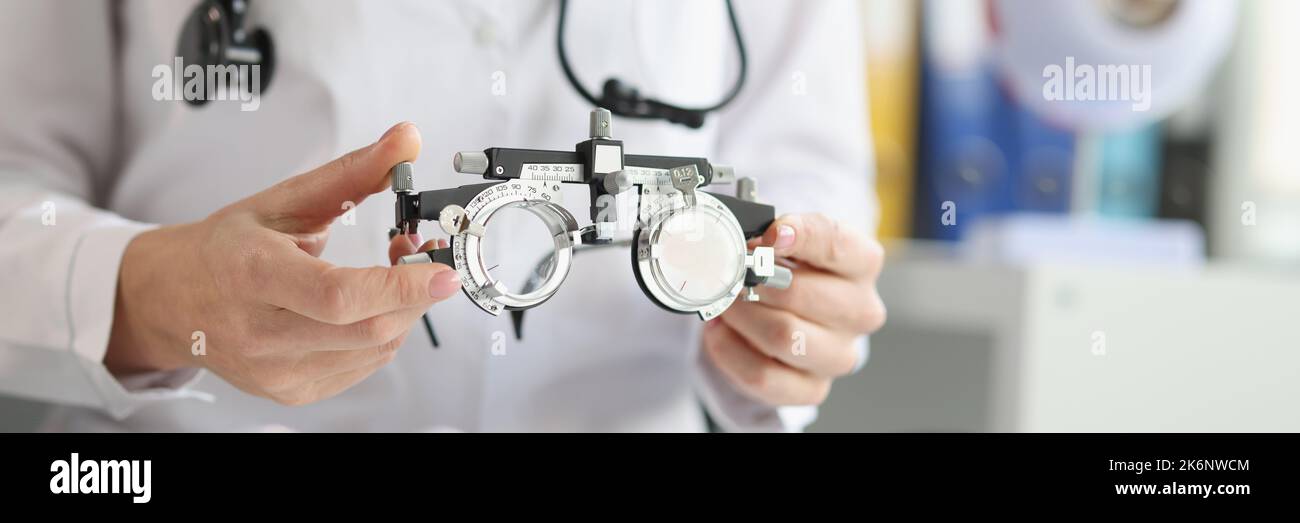 The doctor holds an optical trial spectacle frame, blurry Stock Photo