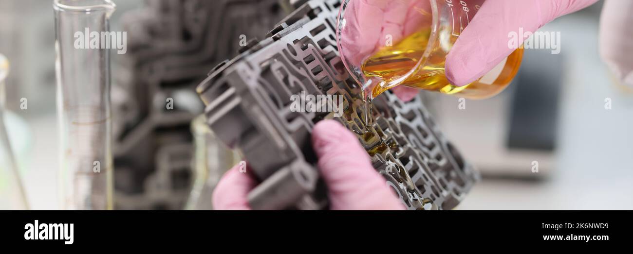 The laboratory assistant pours oil on the gearbox, close-up Stock Photo ...