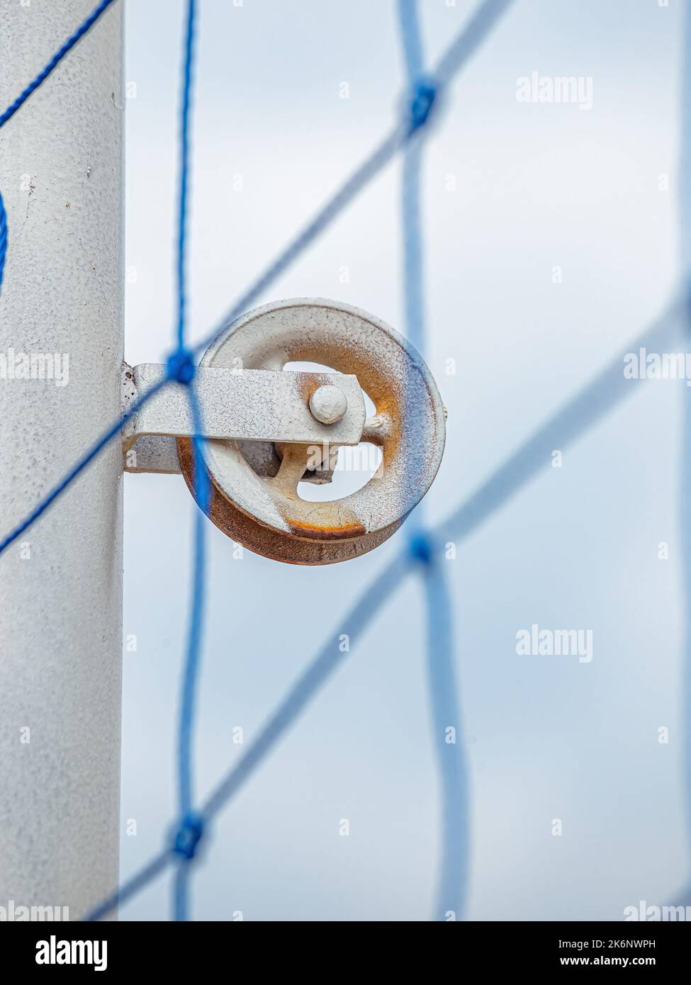 pulley on a metal pole to extend net on volleyball court Stock Photo