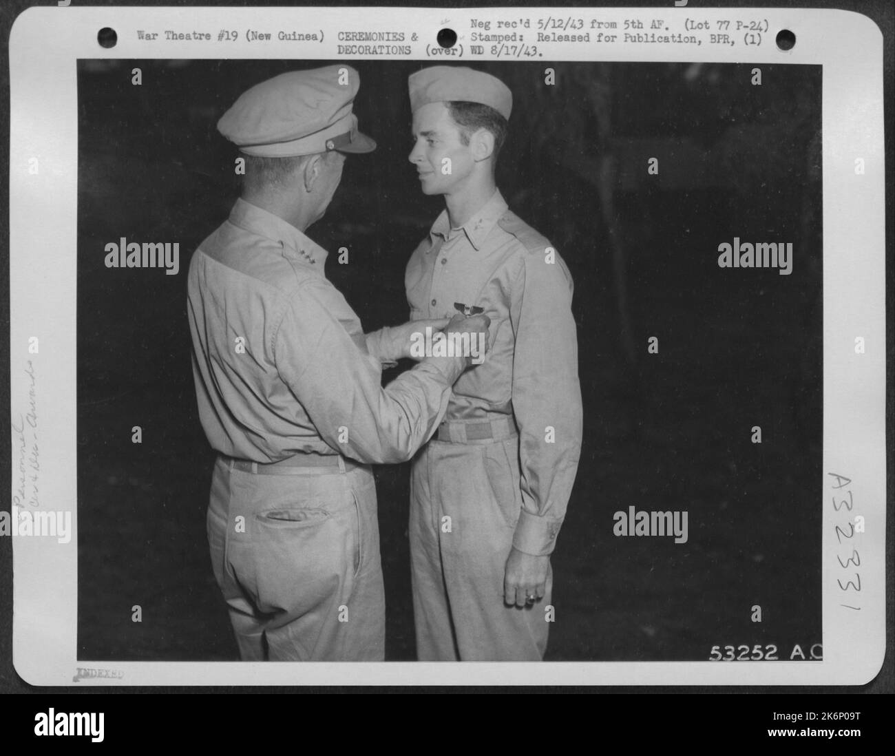 Capt. Curran L. Jones of Columbia, S.C., is pictured being decorated by Lt. General George C. Kenney with the Air Medal and Distinguished Flying Cross, at ceremonies held in New Guinea, on the eve of Jones' departure for the United States and a new Stock Photo
