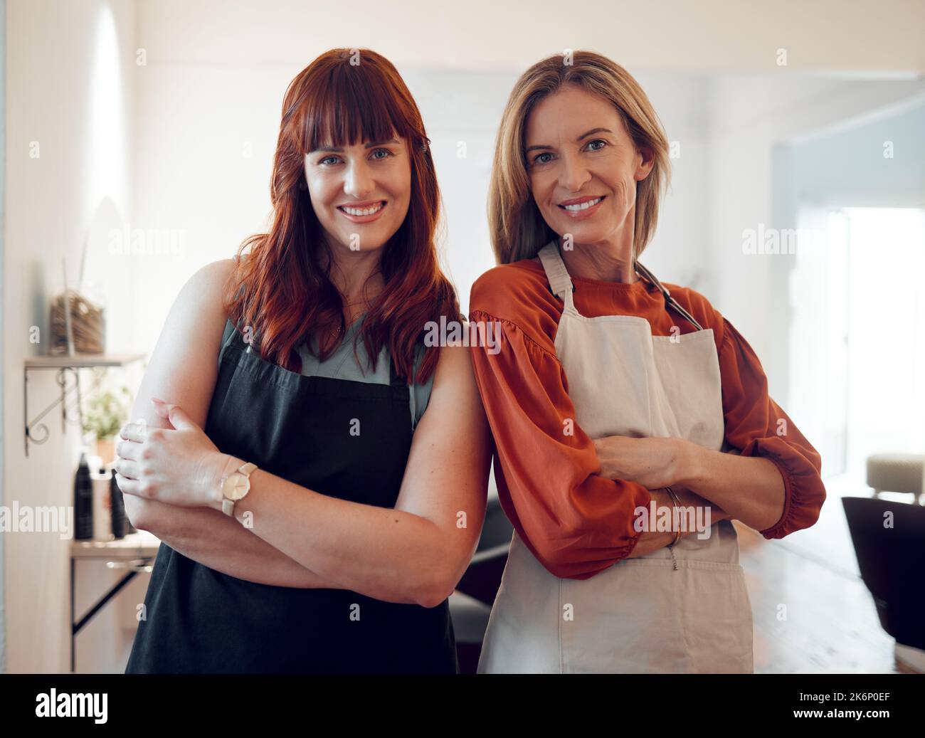 Salon, teamwork and hair care with a woman hairdresser team standing arms crossed in their small business. Collaboration, startup and haircut with a a Stock Photo