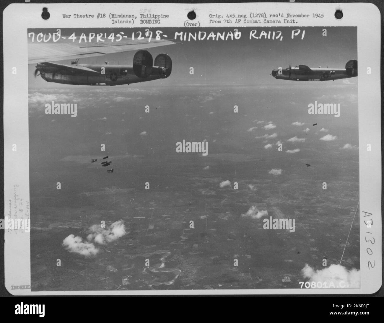 Consolidated B-24 'Liberators' of the 494th Bomb Group release their bombs over Japanese installations just south-east of the village of Bunawan on Mindanao in the Philippine Islands. The object of the raid was to weaken and destroy as many Japanese Stock Photo