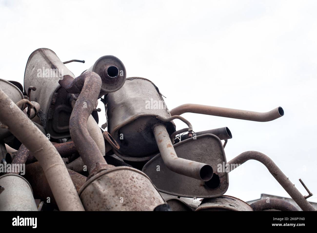 Close view pile of used mufflers at car Old car mufflers. Lot