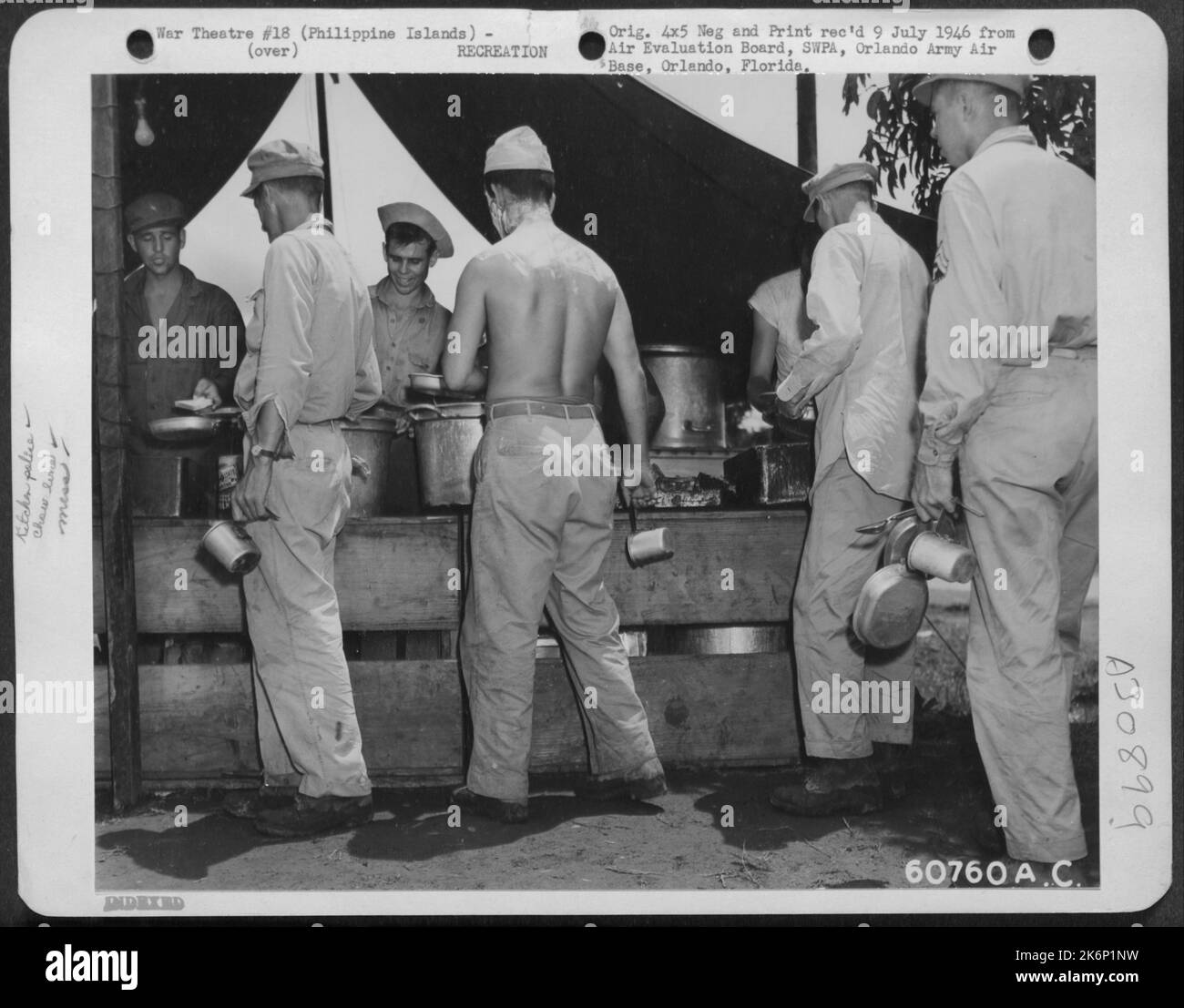 G.I.'s line up for chow at a field kitchen in Manila, Philippine