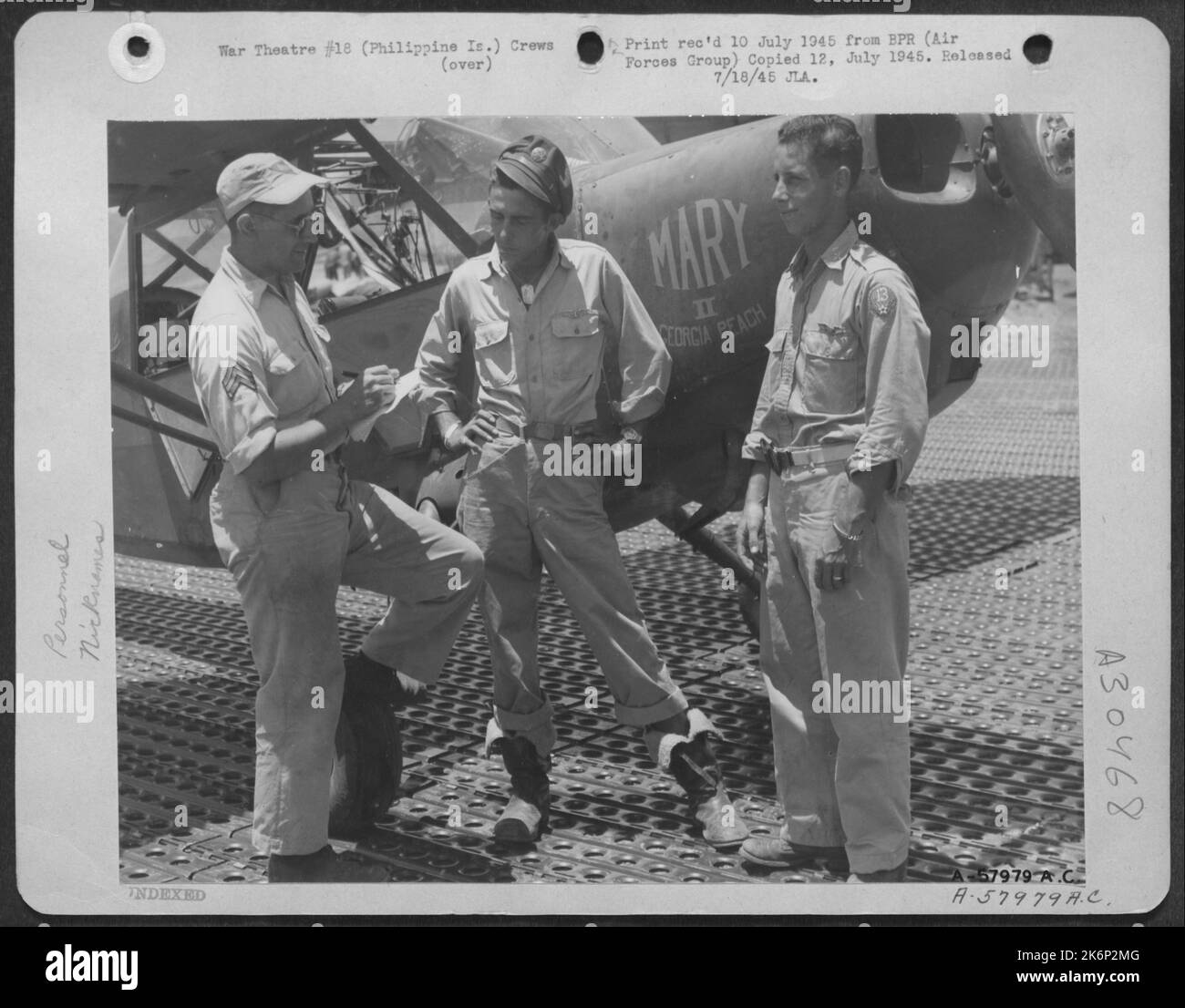 Philippine Islands-Vultee L-5 pilots of the 13th AAF serve long tours of duty. T/Sgt. John W. Gilder, 923 Industry St. Pittsburgh, Pa. (center) completed 1,000 hours of flying time before he was rotated. Homeward bound, He tells Sgt. Stanley G. Maggs Stock Photo