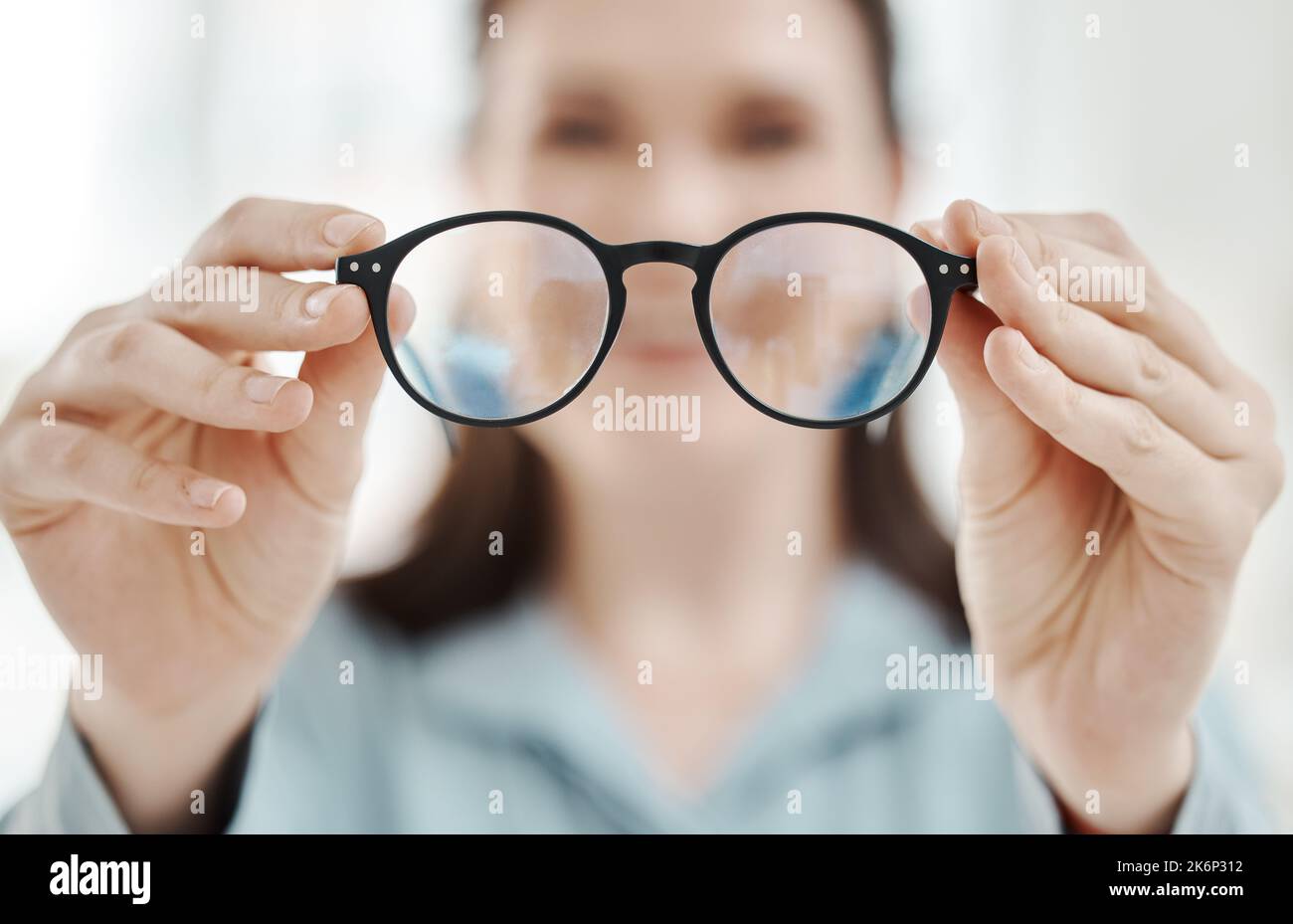 Eyes, vision and glasses with the hands of a woman optometrist holding