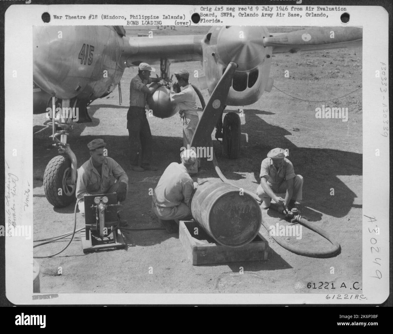 Immediately after mixing the Napalm solution, the filled drums are taken by truck to the waiting plane. Three 55 gallon drums are required to fill each tank and there are two tanks to a fighter-bomber. 894th Chemical Company, 3rd Bomb Group. Elmore Stock Photo