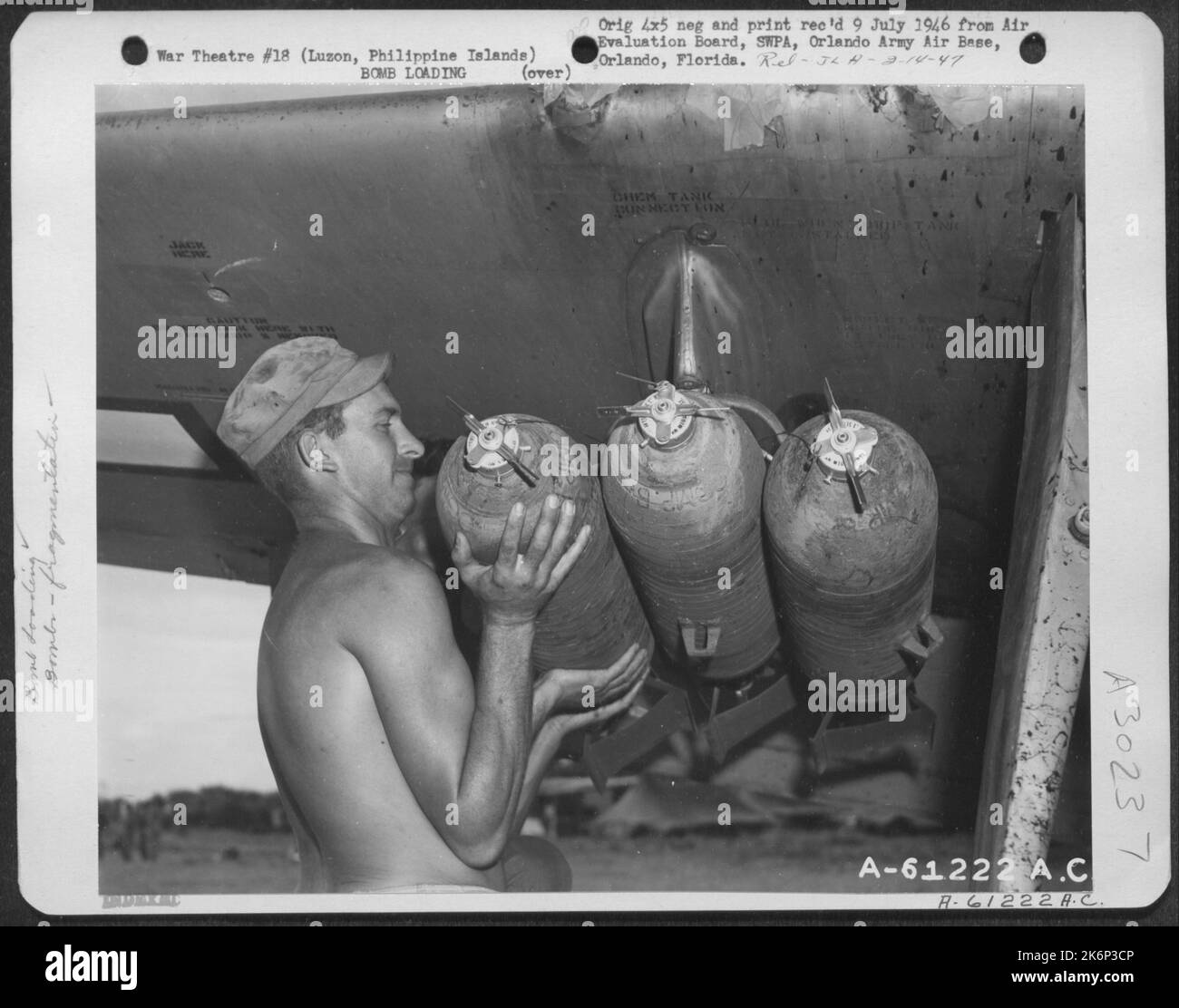 Member of the Armament Crew loads 260 pound fragmentation bombs onto ...