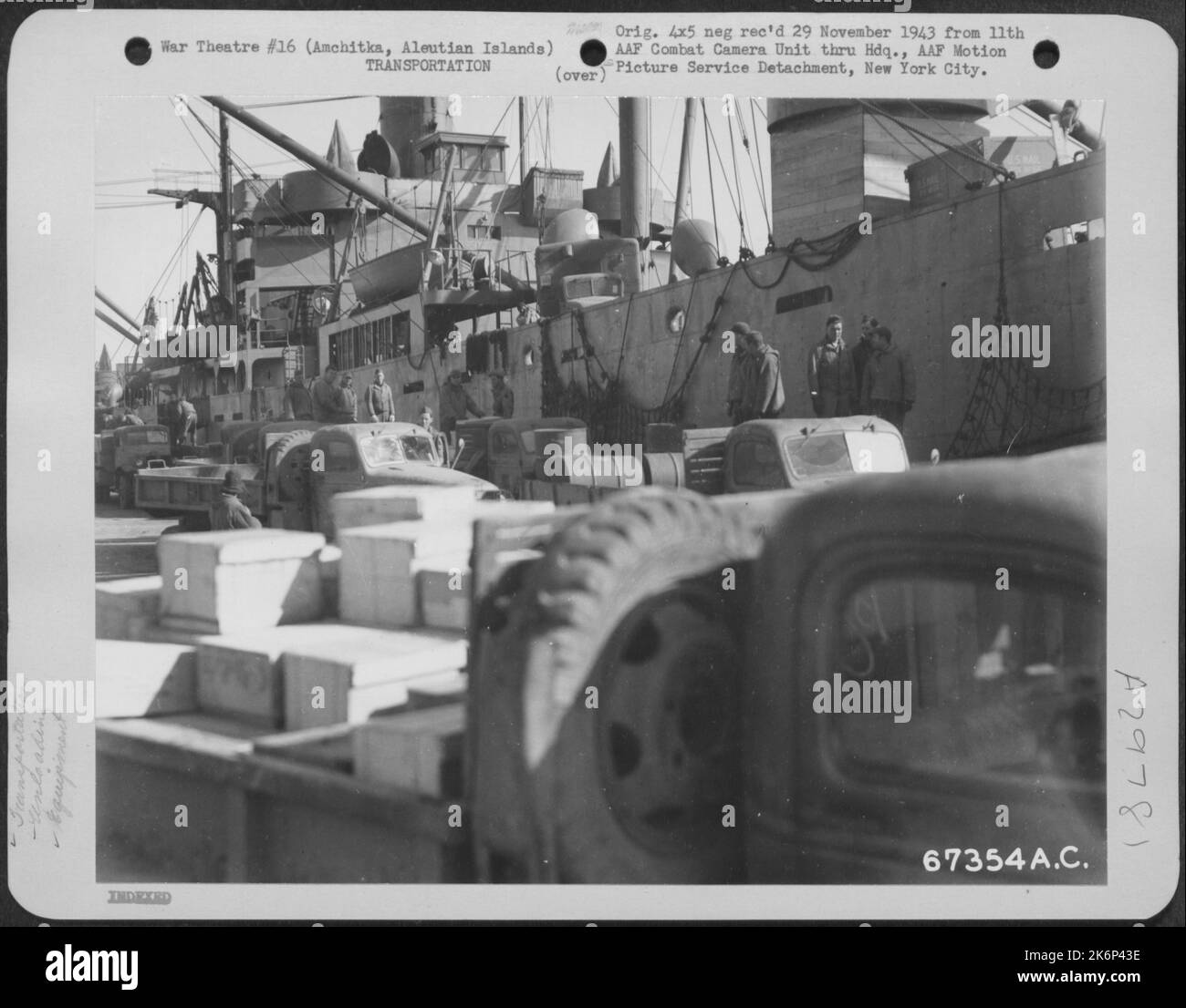 Ships carrying supplies for the 11th Air Force are unloaded at Constantine Harbor in Amchitka, Aleutian Islands. 10 October 1943. Stock Photo