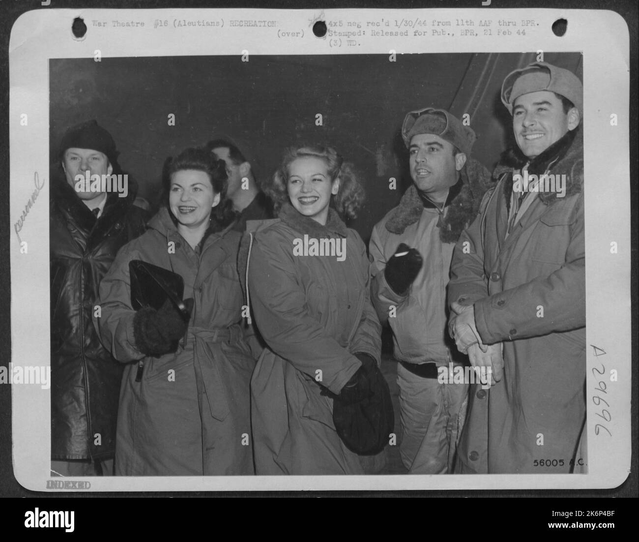 The reason for these heavy coats is that this troupe of entertainers, fresh from Hollywood, are at Amchitka Island, in the cold bleak Aleutians. They were snapped by an AAF photographer shortly after they arrived in an army air transport plane to Stock Photo